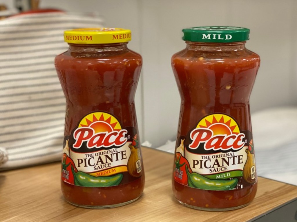 two jars of salsa on wood counter