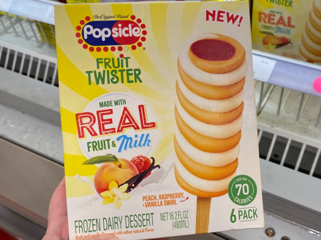 boxeof fruit and cream popsicles in front of store freezer
