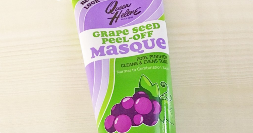 purple and green bottle of Queen Helene Antioxidant Grape Seed Extract Peel Off Masque on wood table