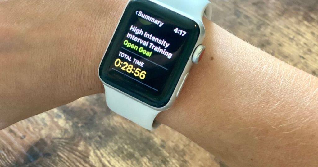 A wrist with an apple watch and workout summary displayed