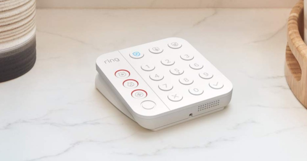 white alarm keypad device on counter in home