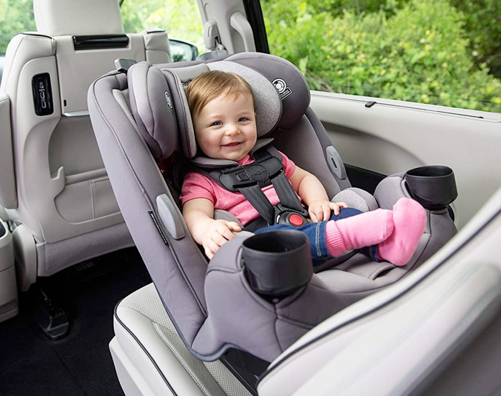 baby seated in a rear facing grey car seat inside car