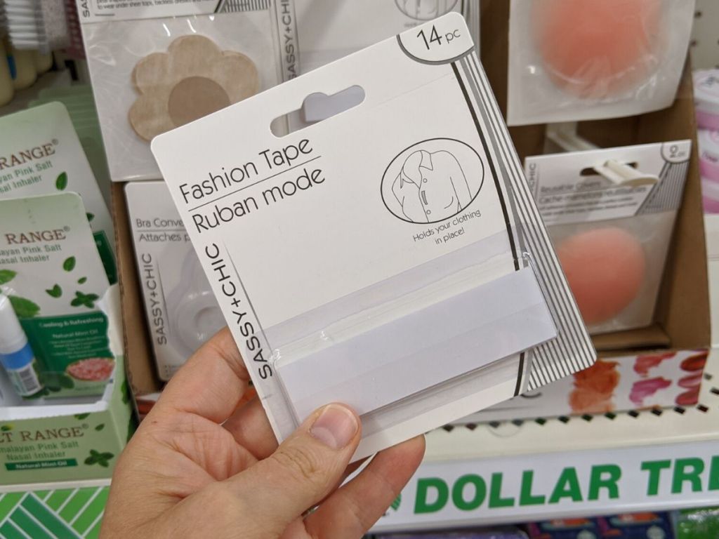 Hand holding package of fashion tape 