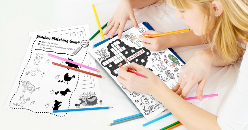 kids using coloring pencils to color on black and white coloring pages