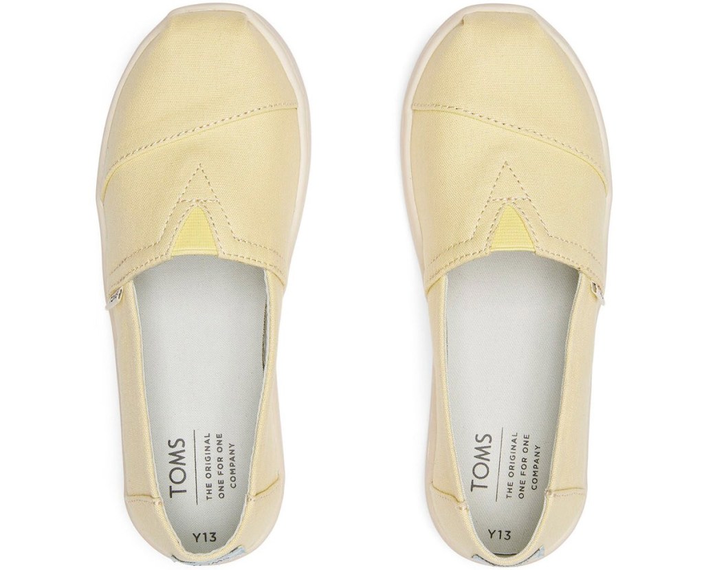 pair of light yellow TOMS slip-on shoes