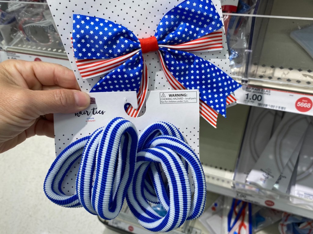 hand holding Americana hair tie and hair bow in store