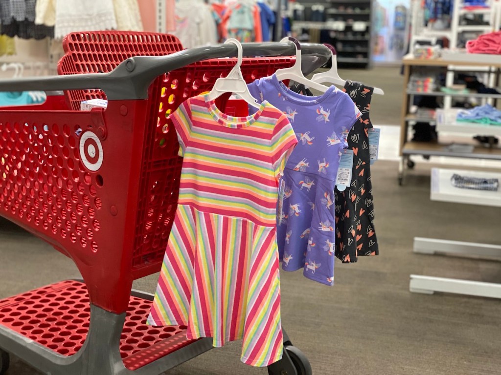 Target cart with three cat and jack dresses hanging from it