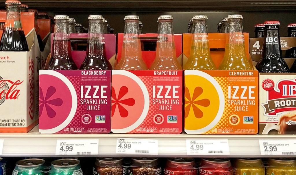 4-packs of izze sparkling drinks in glass bottles on store shelf in various flavors