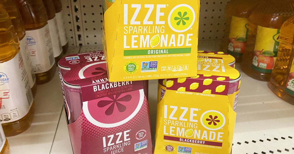 three boxes of izze sparkling juice and lemonade boxes stacked on each other on store shelf