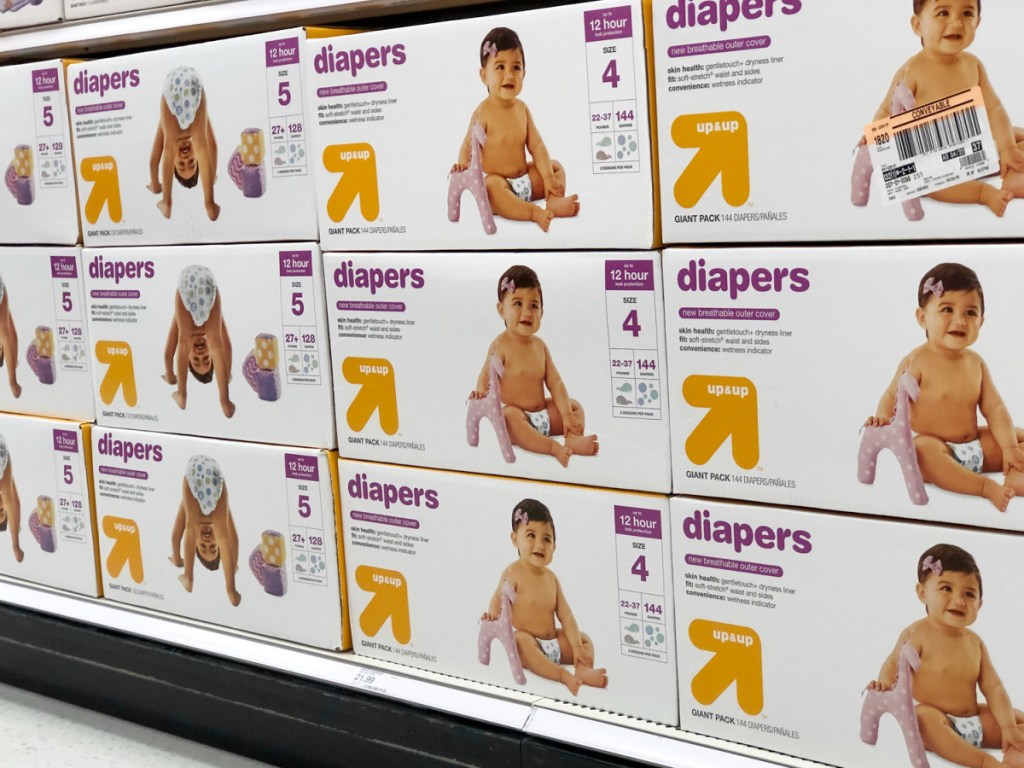 store display shelfs full of white and yellow boxes of up & up brand diapers