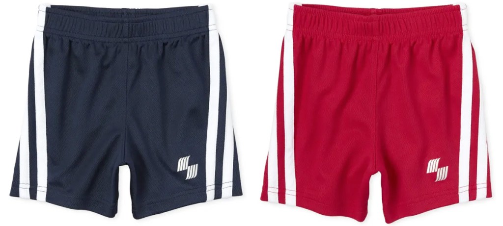 two pairs of boys shorts in navy blue and red with white stripes down the sides