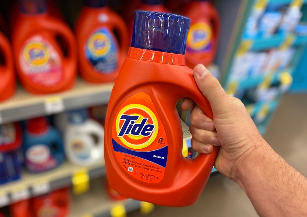 hand holding bottle of Tide laundry detergent