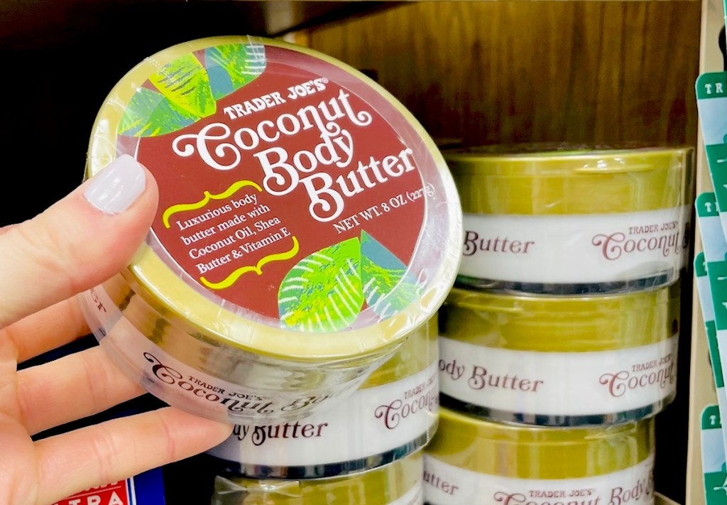 hand holding a jar of coconut whipped body butter in trader joes 