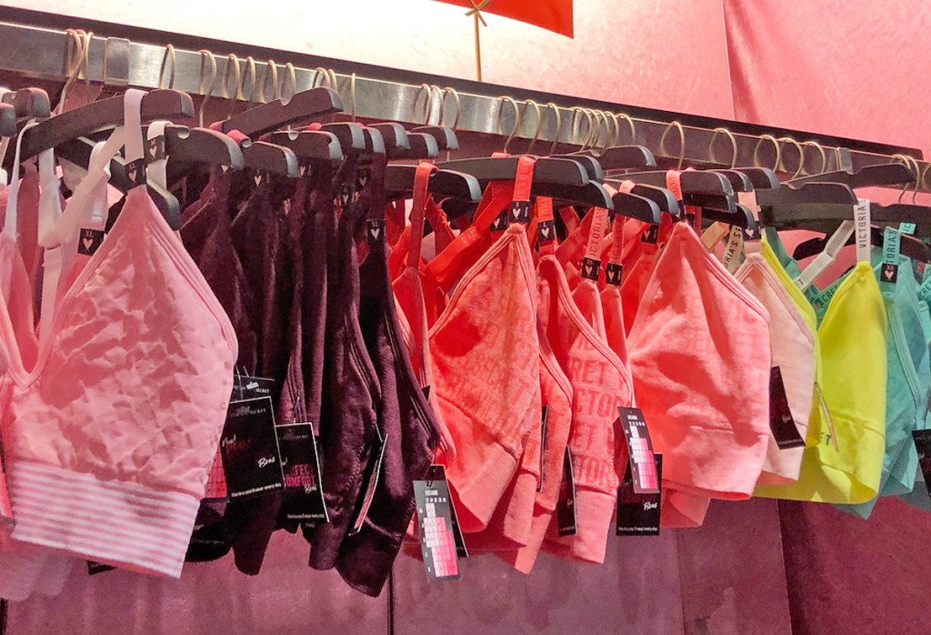 various colors of bralettes on hangers on store display