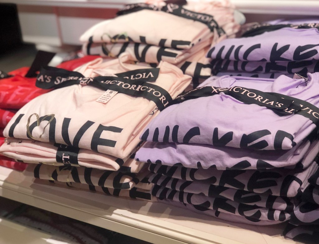 pink and purple sleepshirts folded on store display table