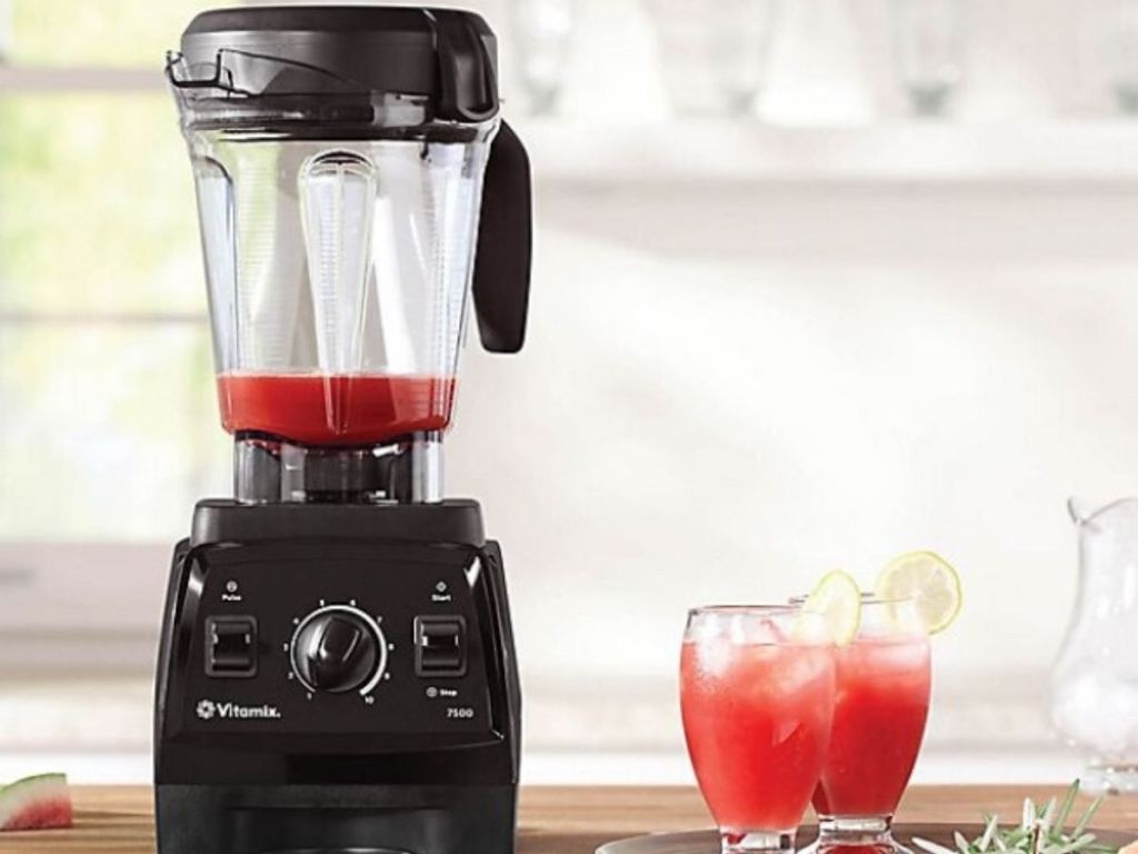 high powered blender with smoothies next to it