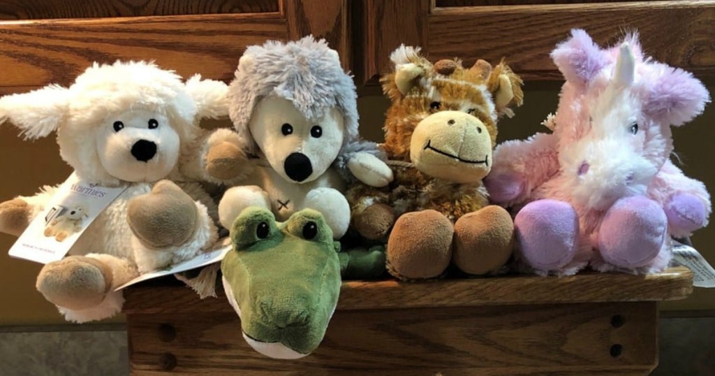 collection of microwavable plush toys on a wooden bench