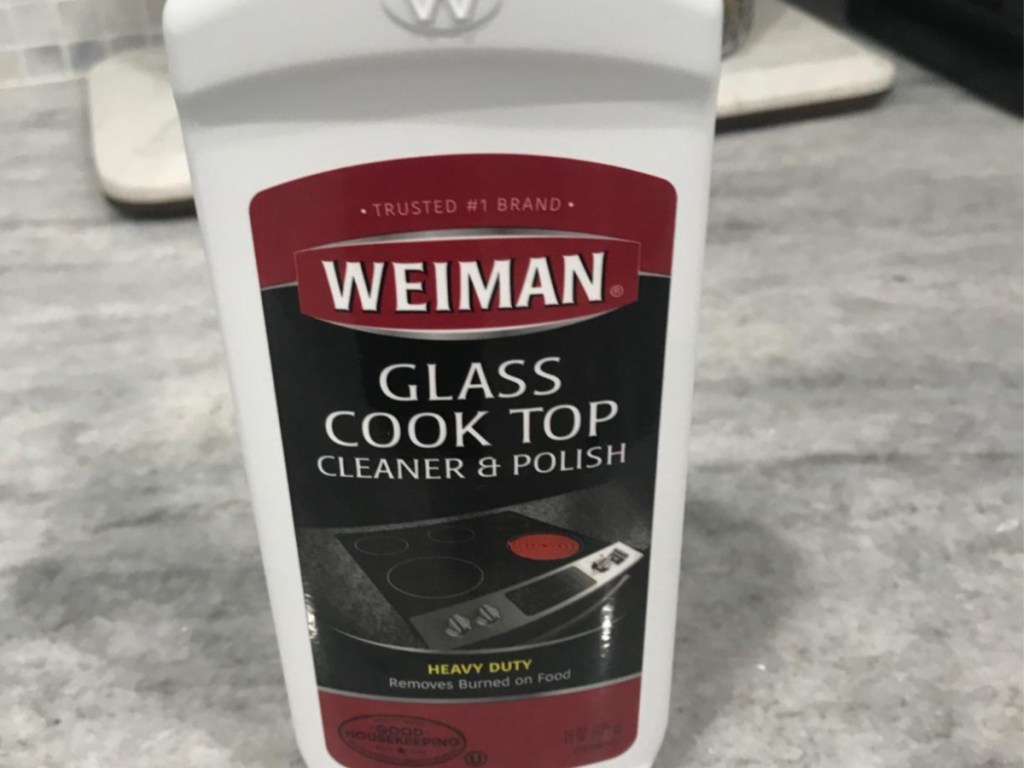 bottle of glass cleaner and polish on marble counter