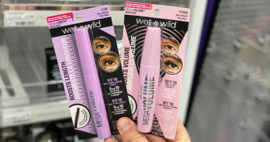 hand holding two packaged mascaras in store