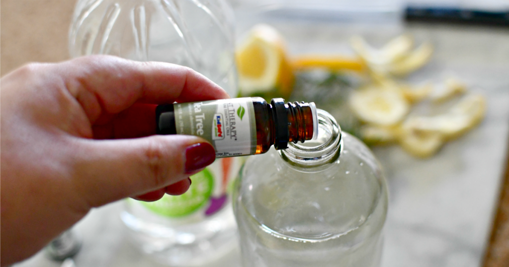 adding tea tree oil to water bottle