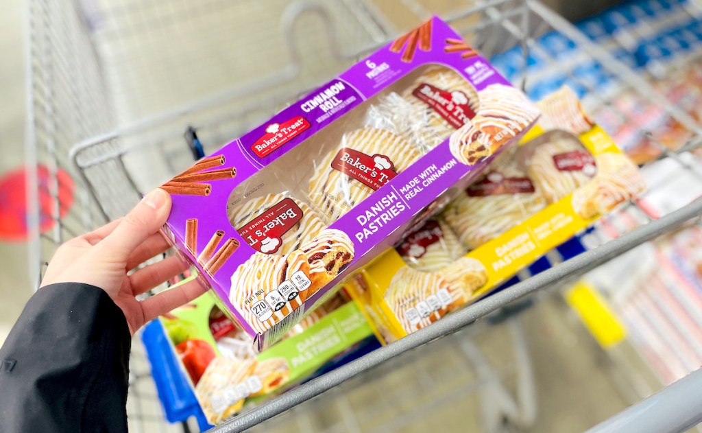 hand holding box of danish pastries in aldi cart