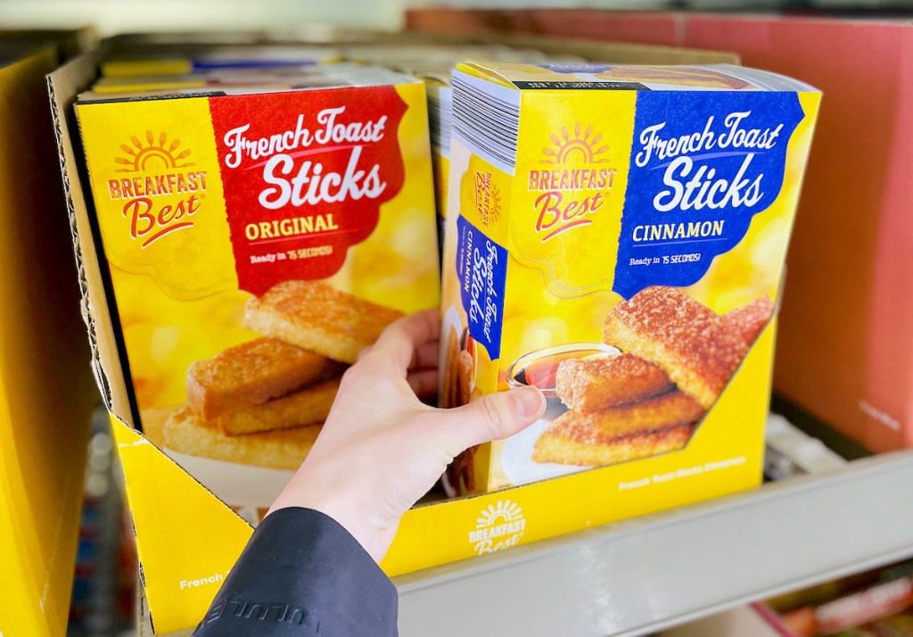 hand pulling out box of french toast sticks from freezer section