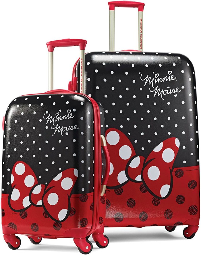 stock image of two pieces of luggage with minnie mouse's red bow