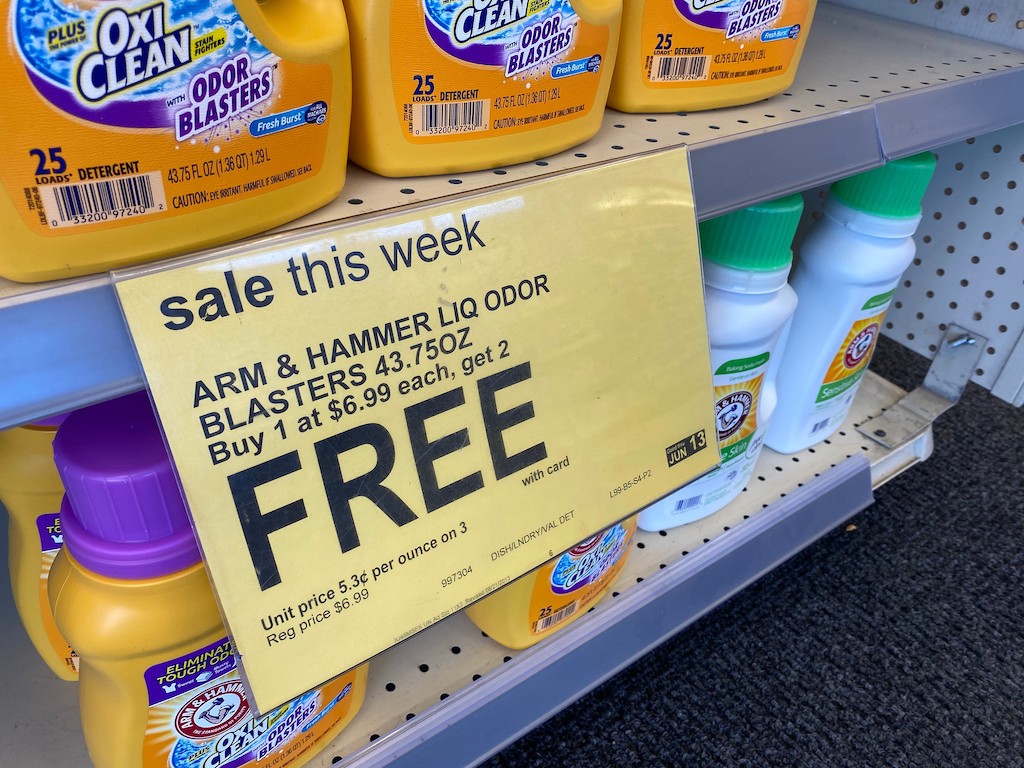 Arm & Hammer Walgreens sale sign with laundry detergent on shelves 
