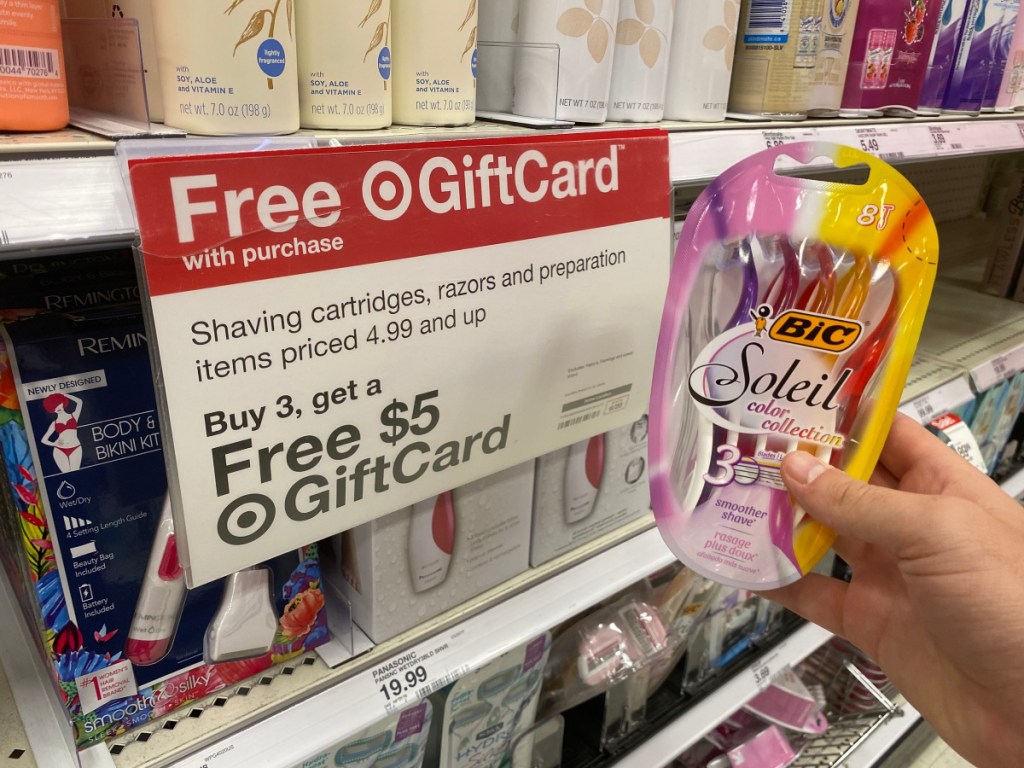 hand holding up BIC Soleil razors in front of free gift card sign