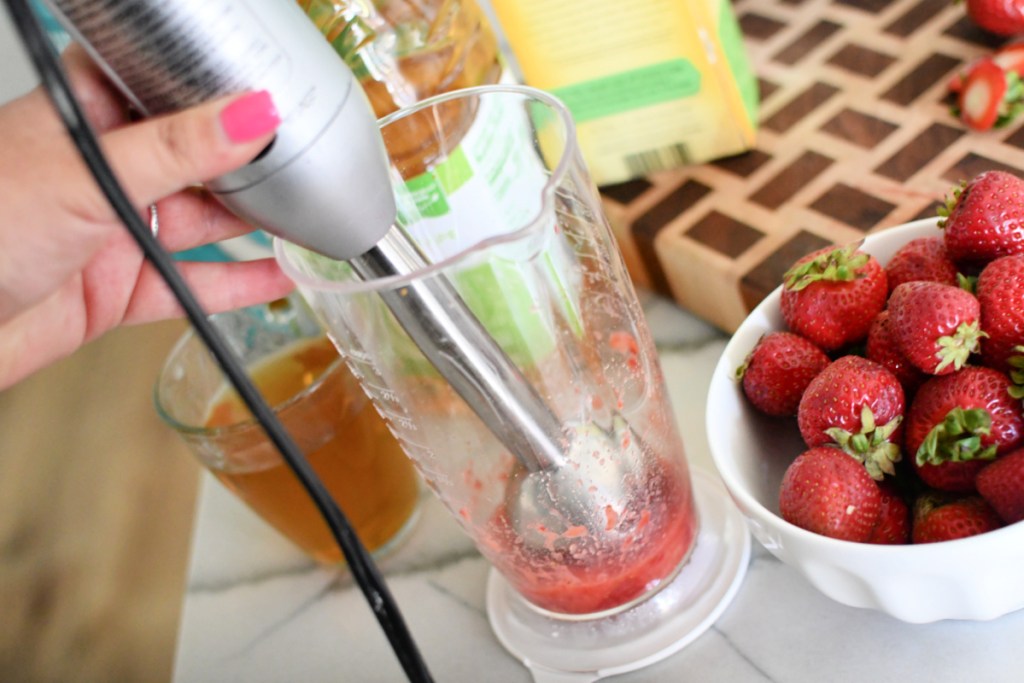 blending strawberries with stick blender
