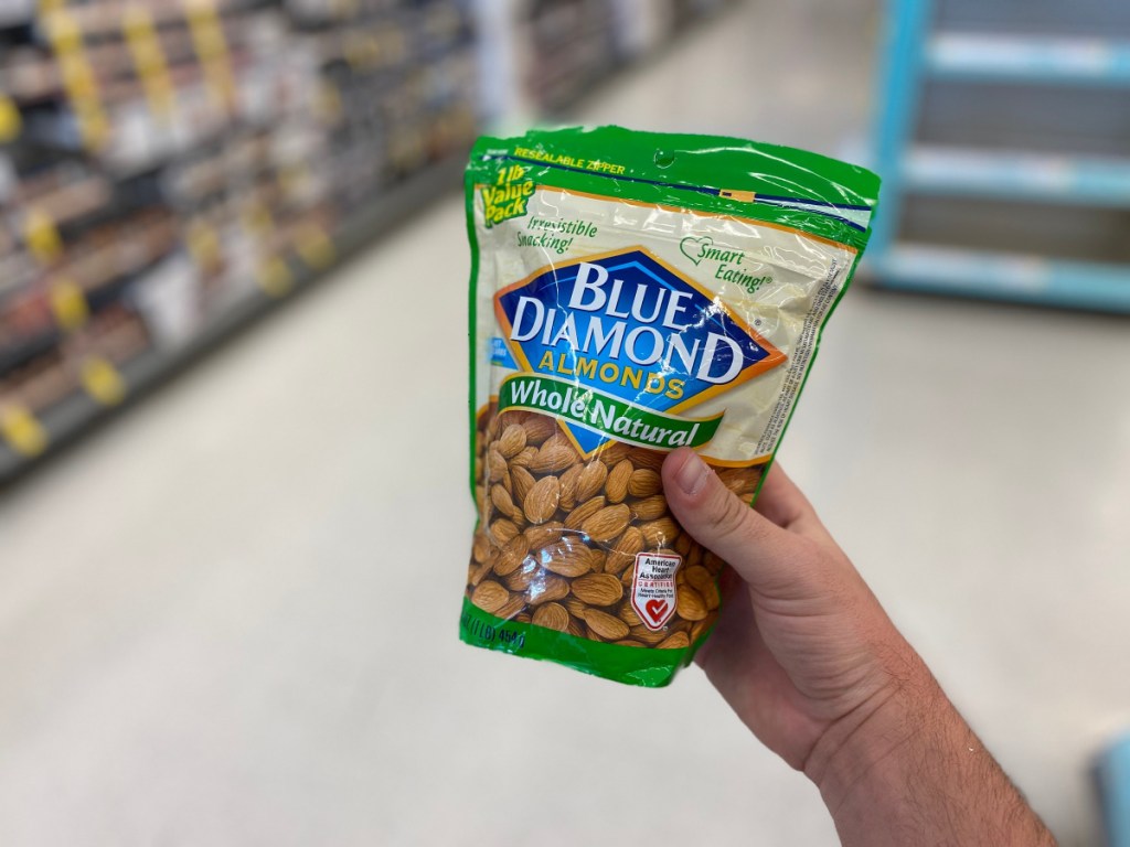 hand holding green back of Blue Diamond Almonds