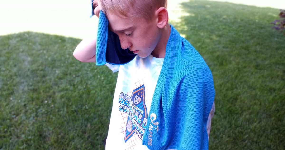 boy using cooling towel for neck from amazon