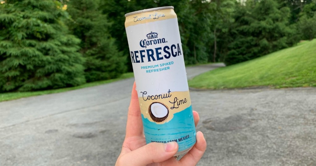 holding Corona Refresca coconut lime beverage 