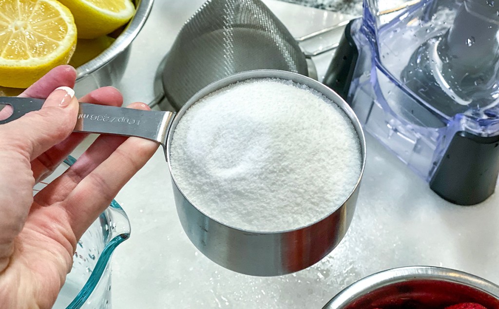 measuring cup with white granulated sugar