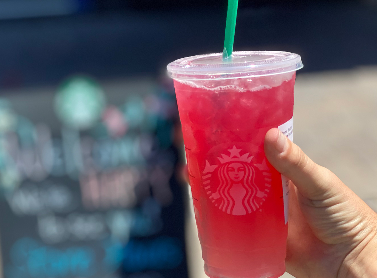hand holding Starbucks Dragonfruit Lemonade Refresher with passion tea