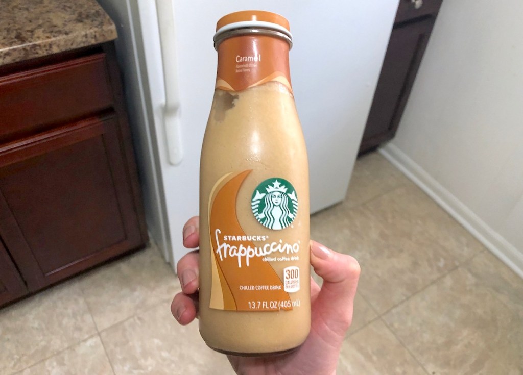 hand holding a bottle of caramel starbucks frappuccino