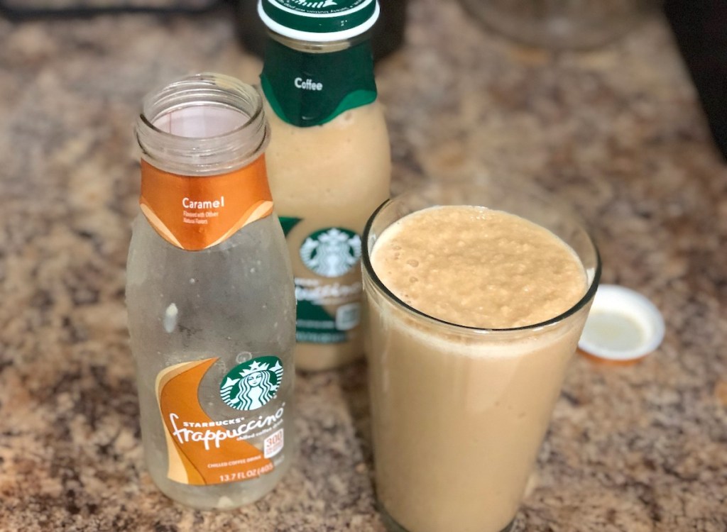 empty starbucks bottle with glass full of frappuccino
