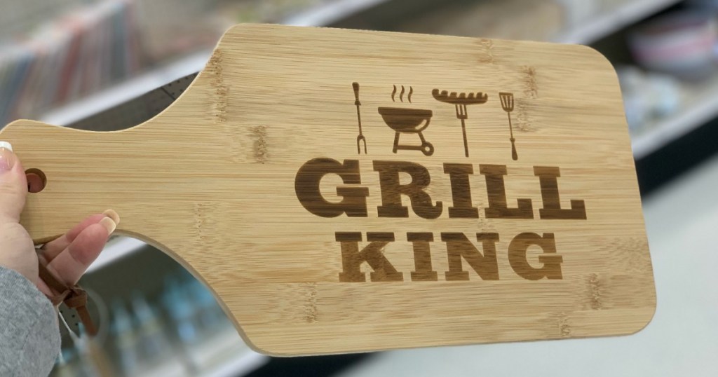 hand holding cutting board by store display