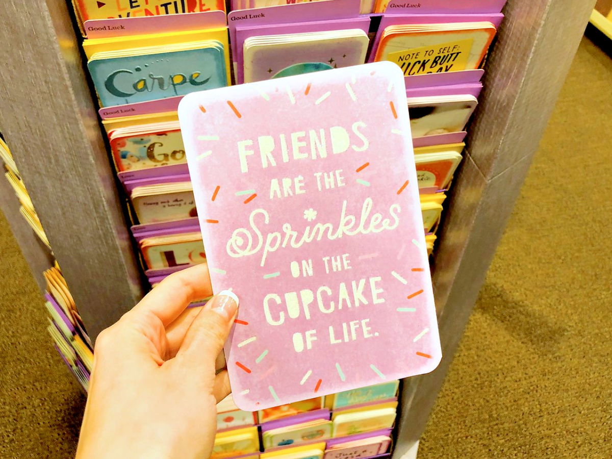 hallmark card in person's hadn with sprinkles and thoughtful message