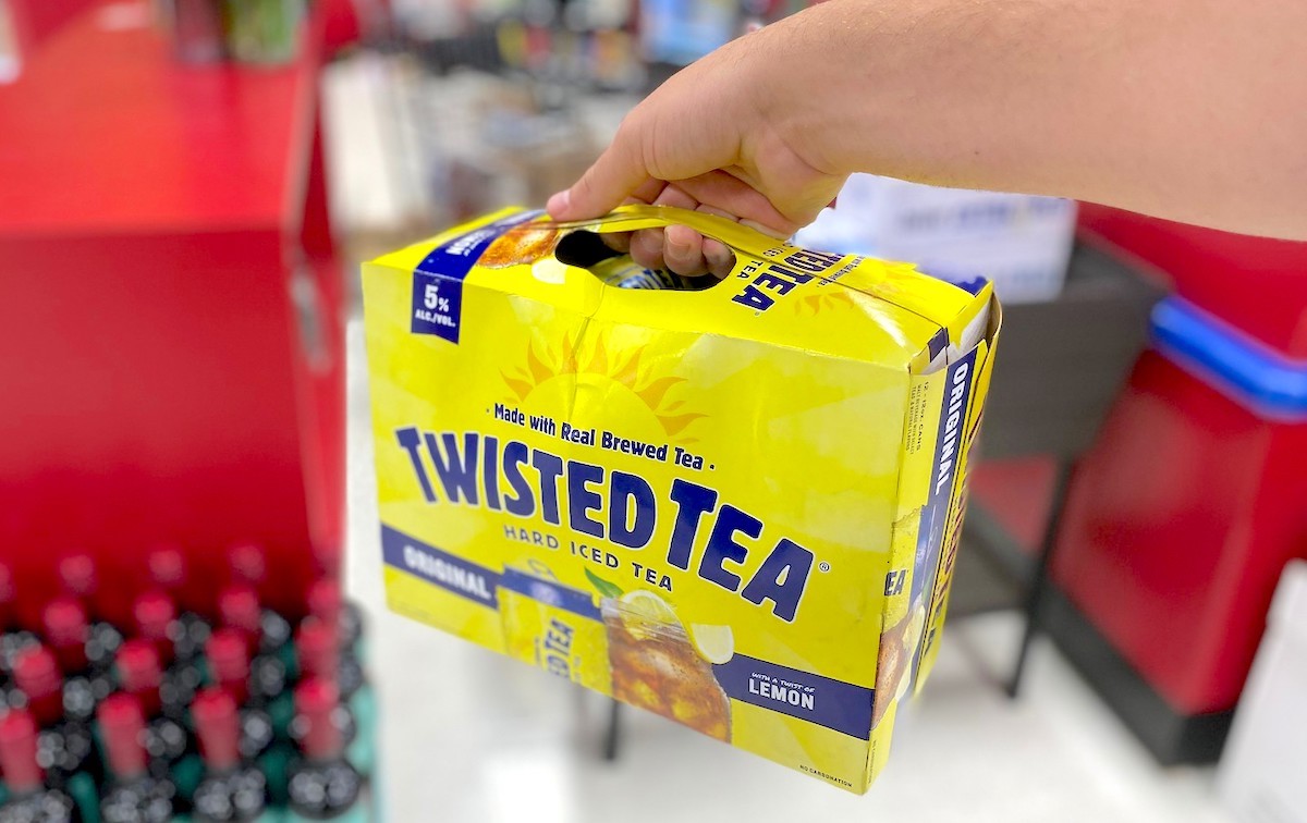 hand holding a box of yellow twisted tea