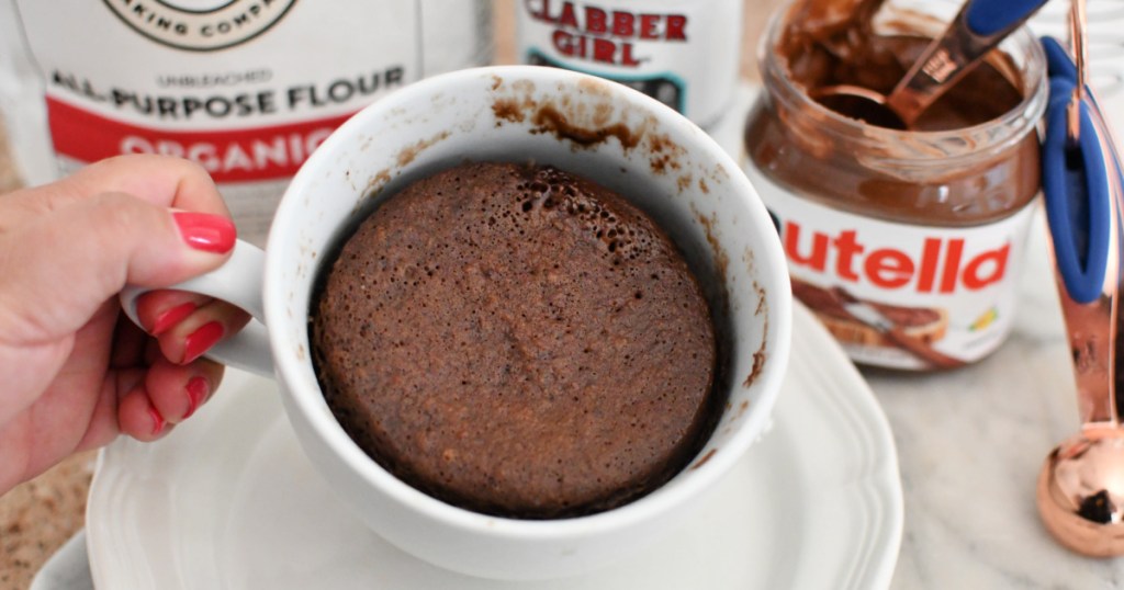 holding a nutella mug cake after cooking