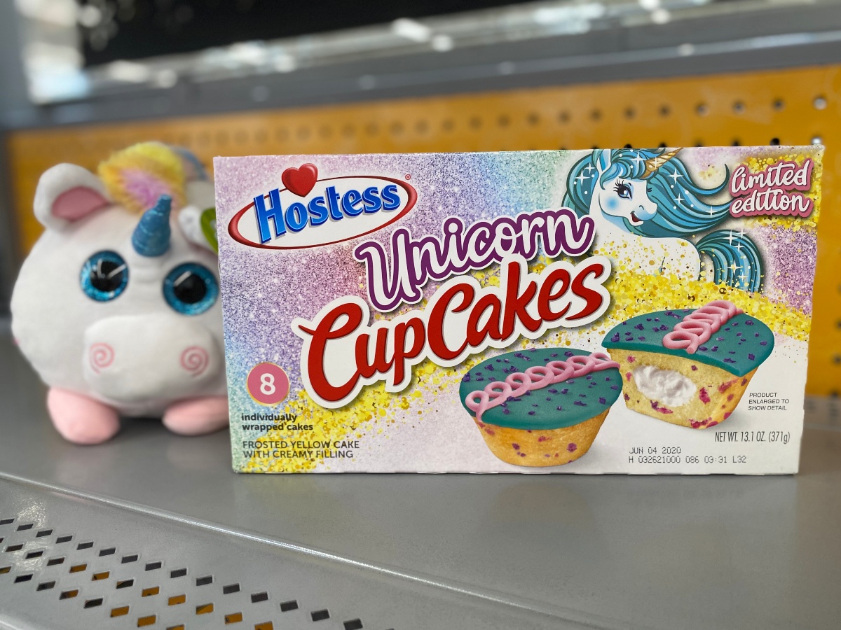 Hostess Unicorn Cupcakes next to a plush unicorn