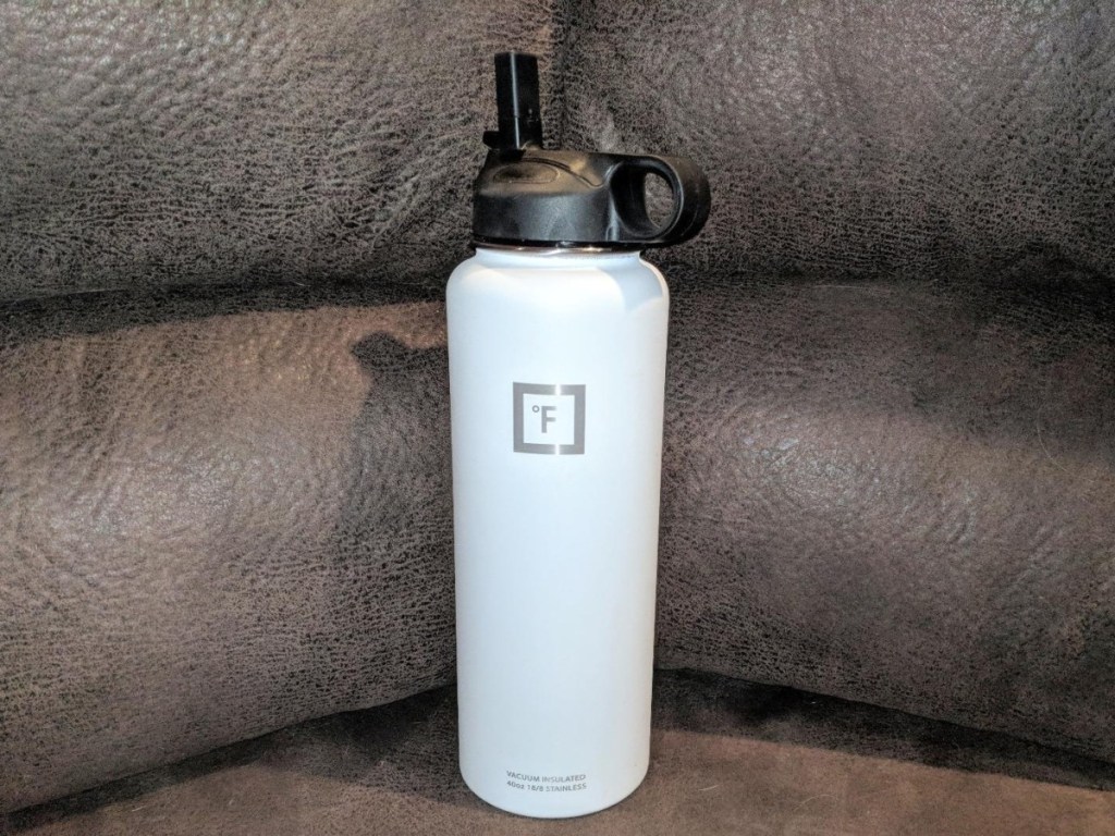 white watter bottle on brown leather couch