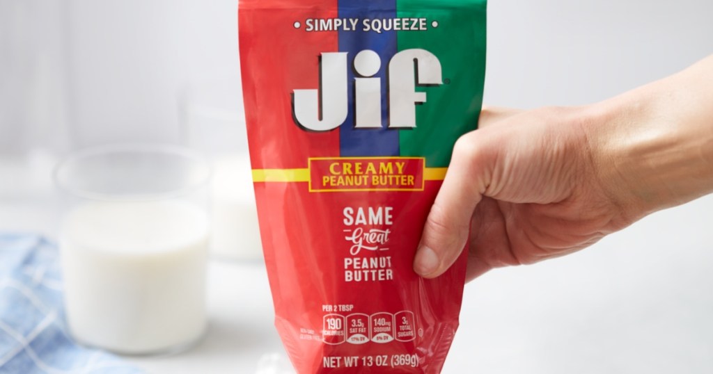 hand squeezing peanut butter from Jif tube