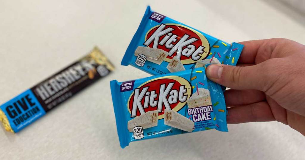 hand holding two Kit Kat Birthday bars