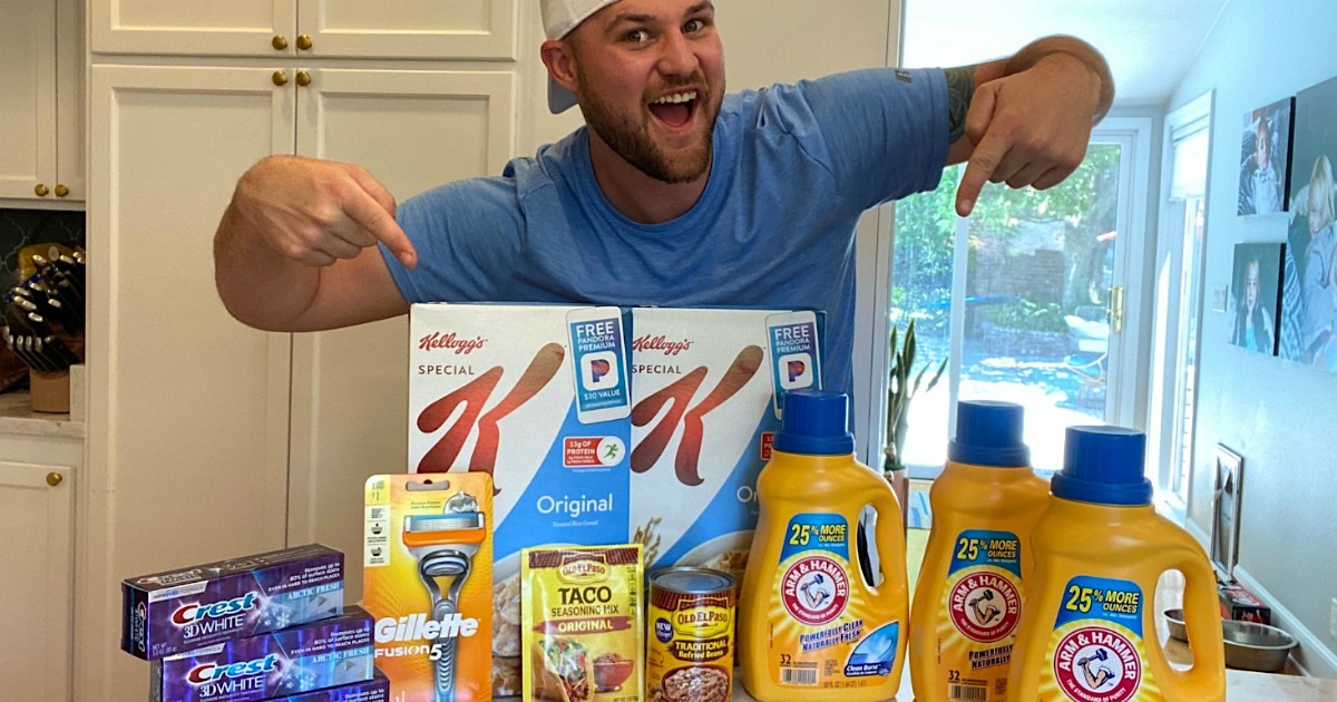 man pointing at Walgreens haul on kitchen counter 