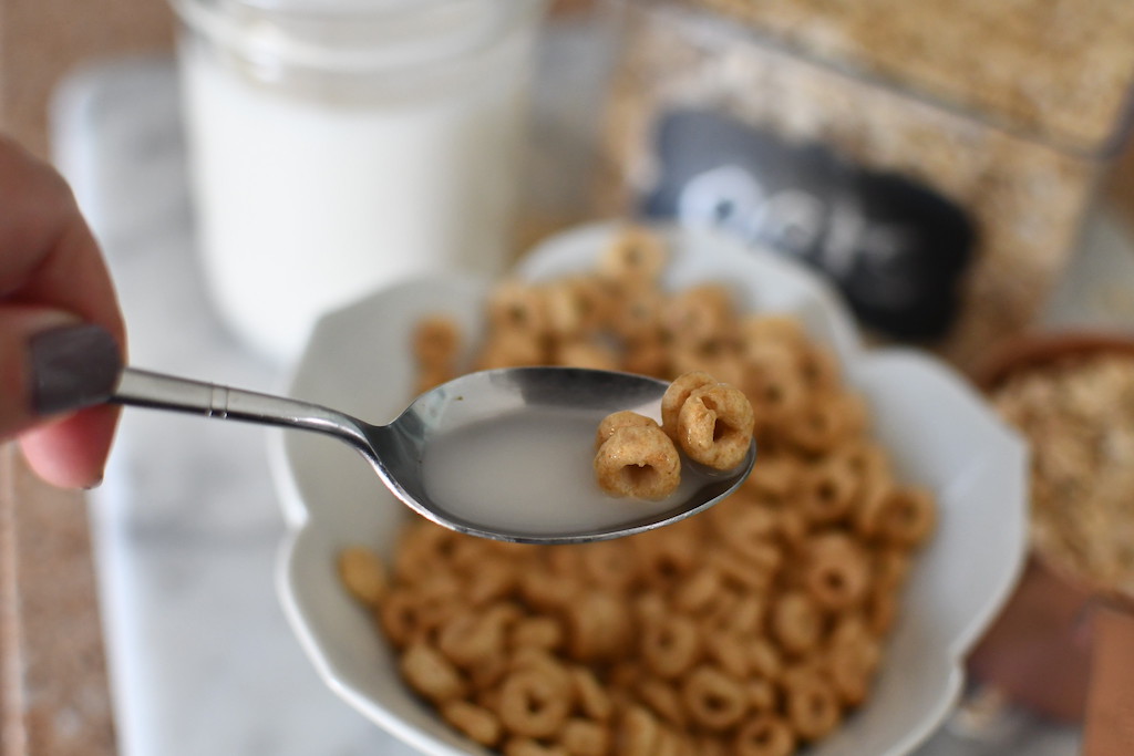 oat milk on spoon with cereal