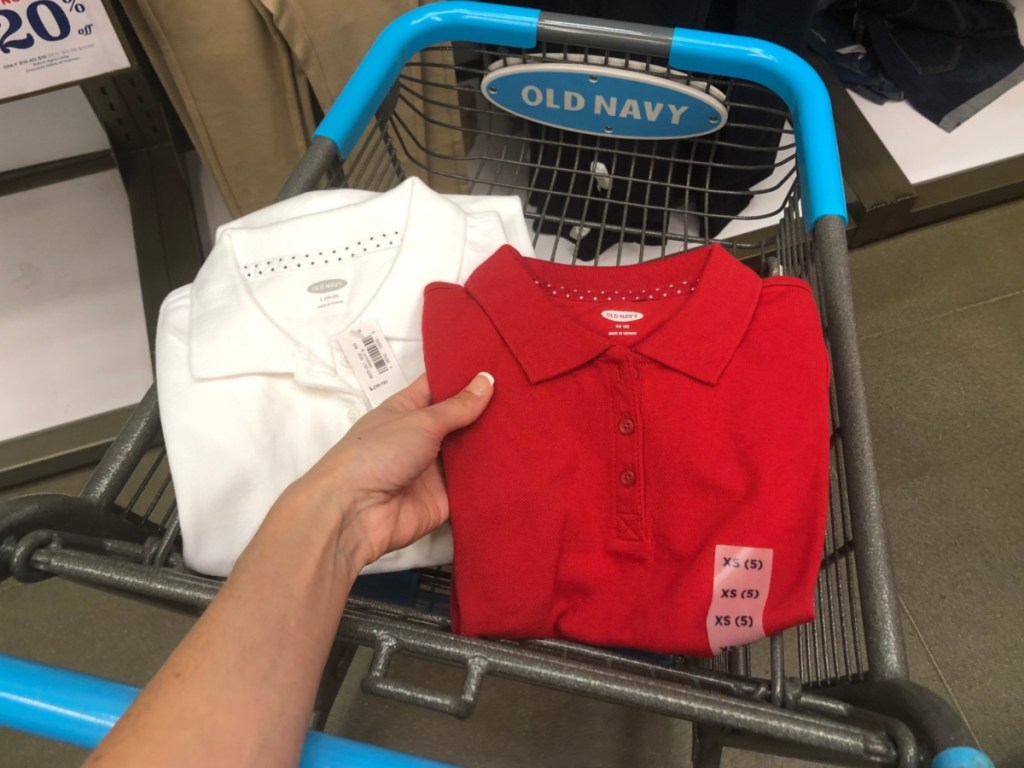 hand holding red polo with white polo also in old navy cart