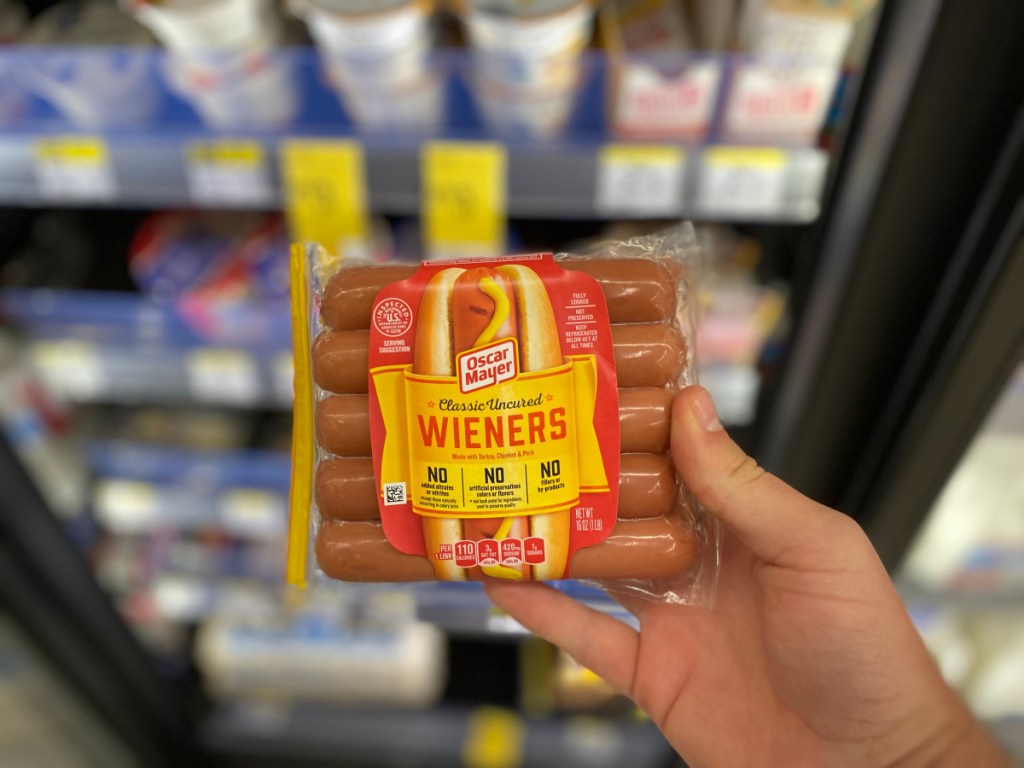 hand holding package of Oscar Mayer weiners