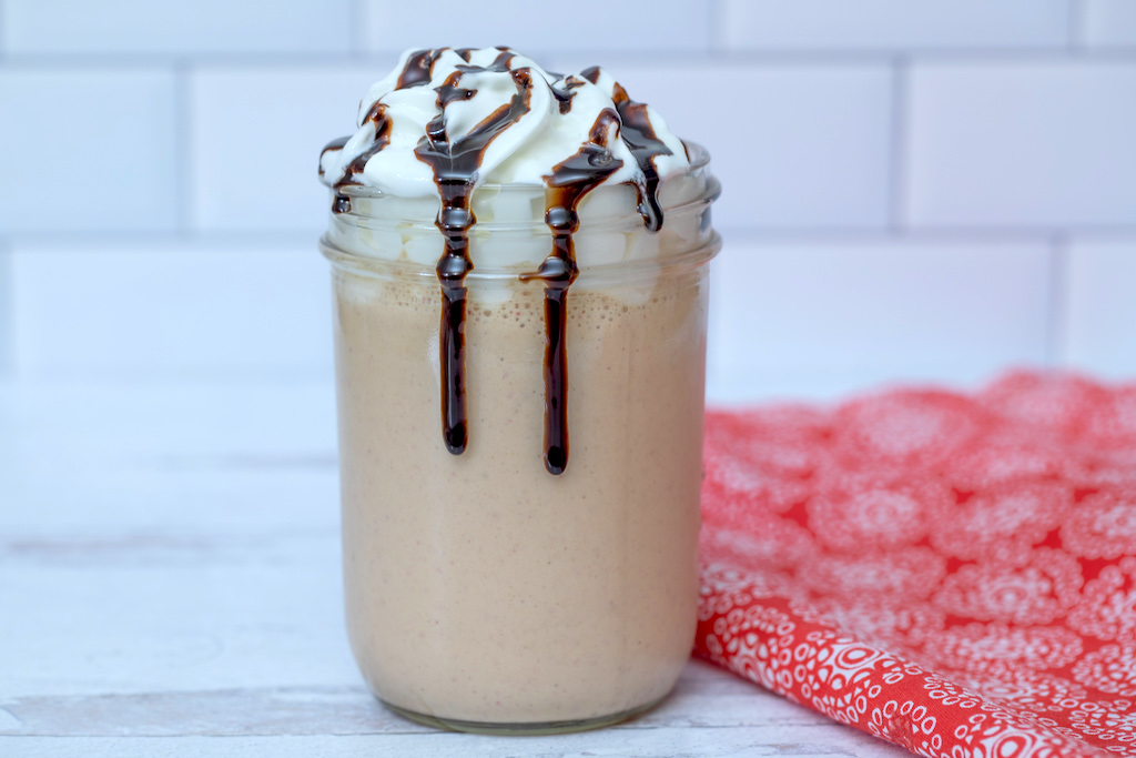 peanut butter and jelly shake with chocolate syrup and whipped cream